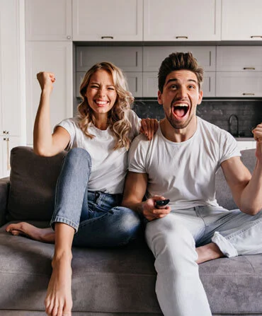 Una coppia guarda la televisione insieme sul divano